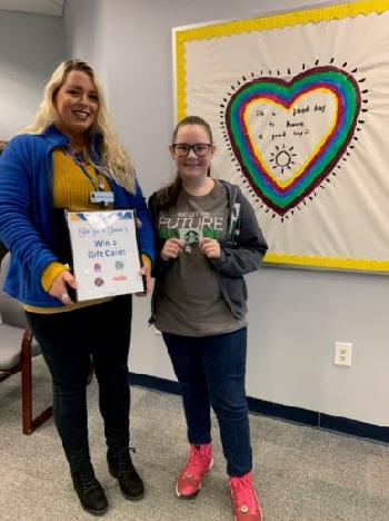 Harper Creek High School student receives a gift card from our Beaver Dam Student-Run Branch.